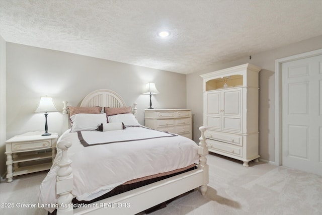 bedroom with light carpet and a textured ceiling