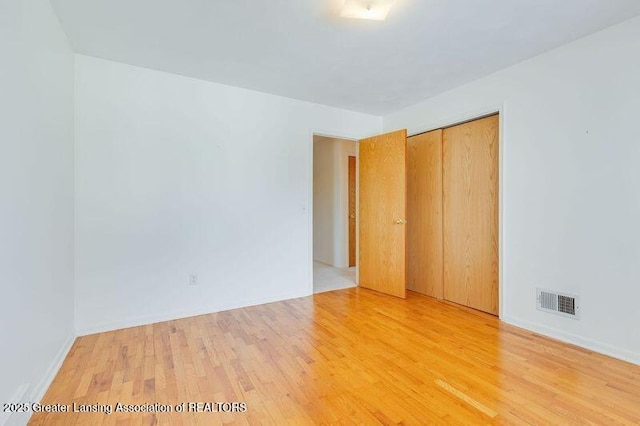 empty room with hardwood / wood-style floors