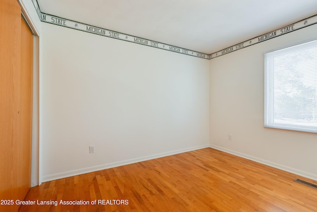 unfurnished room featuring hardwood / wood-style flooring