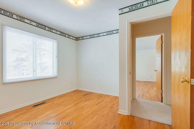 unfurnished room featuring hardwood / wood-style floors