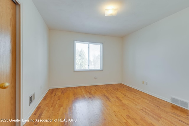 unfurnished room with light hardwood / wood-style flooring