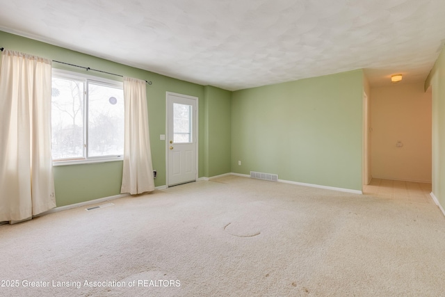 carpeted spare room featuring a textured ceiling