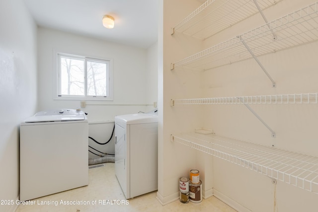 laundry area featuring washing machine and clothes dryer