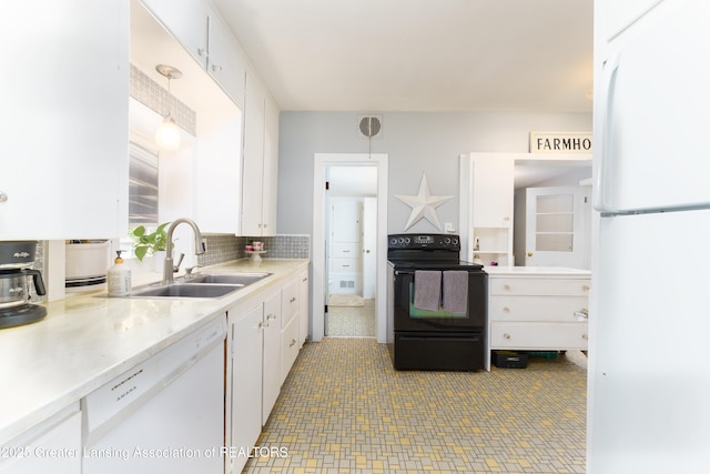 kitchen with white appliances, white cabinetry, light countertops, and a sink