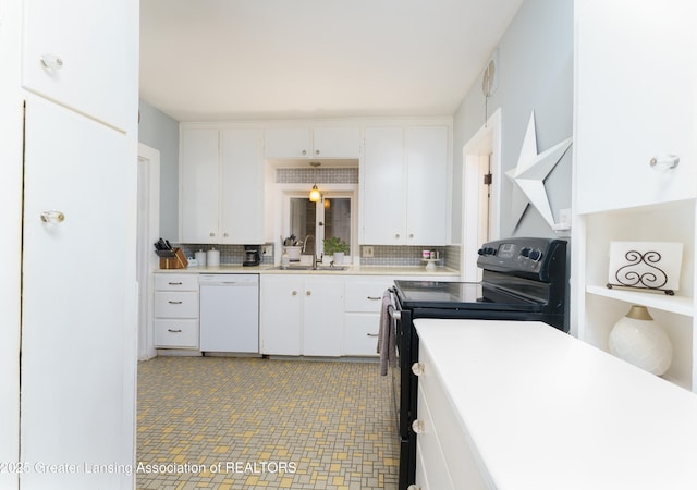 kitchen featuring dishwasher, light countertops, black electric range, white cabinetry, and a sink