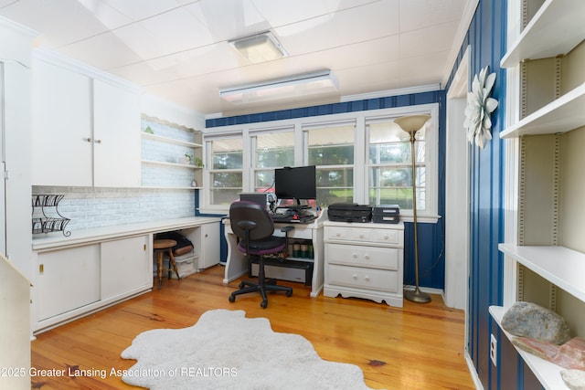 office area with crown molding and light wood-style flooring