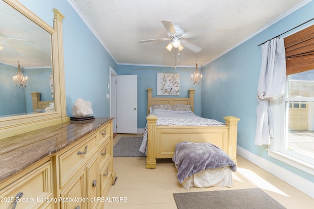 bedroom featuring light wood-style floors, ornamental molding, a textured ceiling, and ceiling fan with notable chandelier