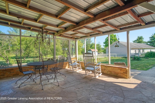 unfurnished sunroom with a chandelier