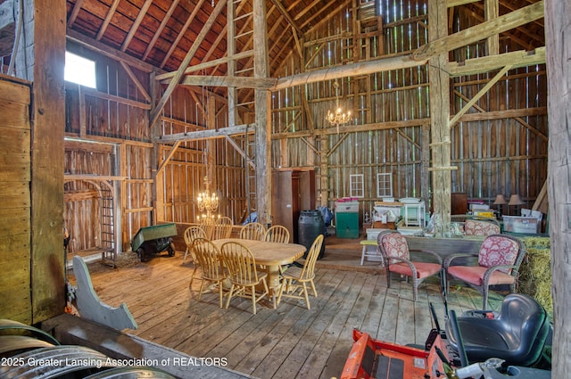 misc room with high vaulted ceiling and wood-type flooring