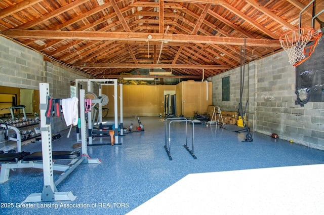 interior space with concrete block wall and vaulted ceiling