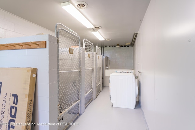 interior space featuring washer / clothes dryer, visible vents, and concrete floors