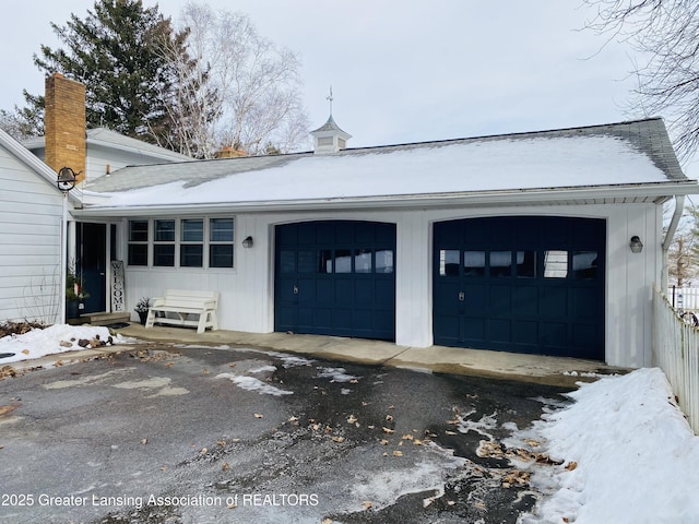 garage featuring aphalt driveway