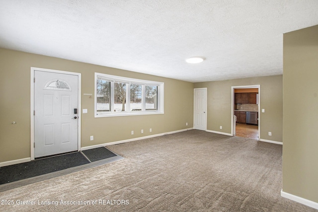 foyer with carpet floors and a textured ceiling