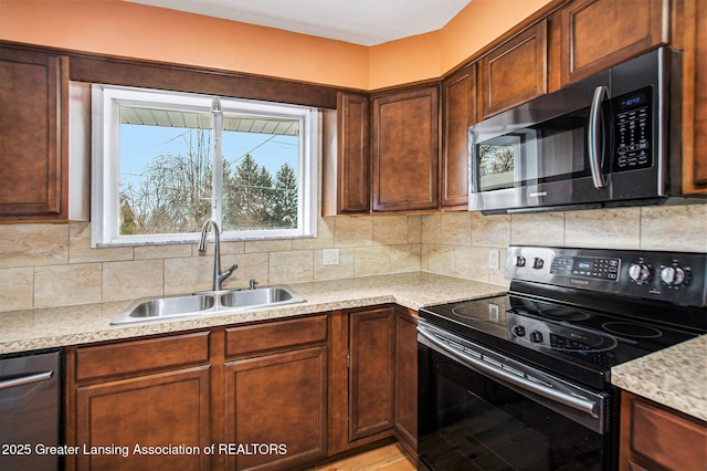 kitchen featuring tasteful backsplash, appliances with stainless steel finishes, and sink