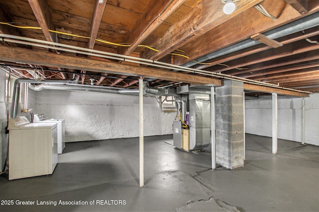 basement with washer and dryer and heating unit