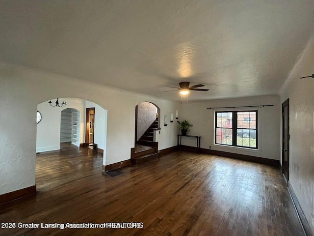 unfurnished room featuring dark wood-type flooring and ceiling fan