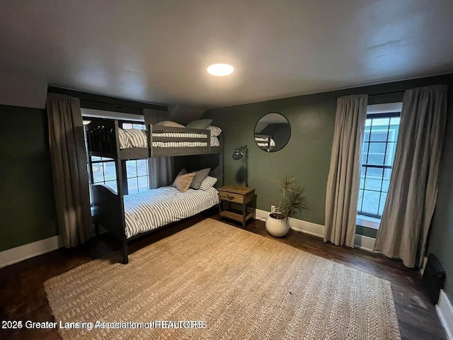 bedroom with dark hardwood / wood-style flooring