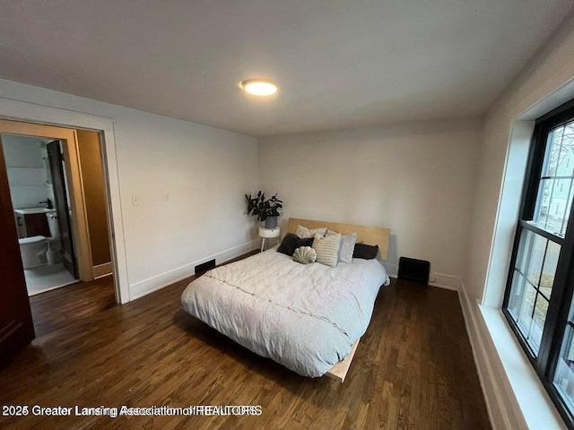 bedroom with dark hardwood / wood-style flooring