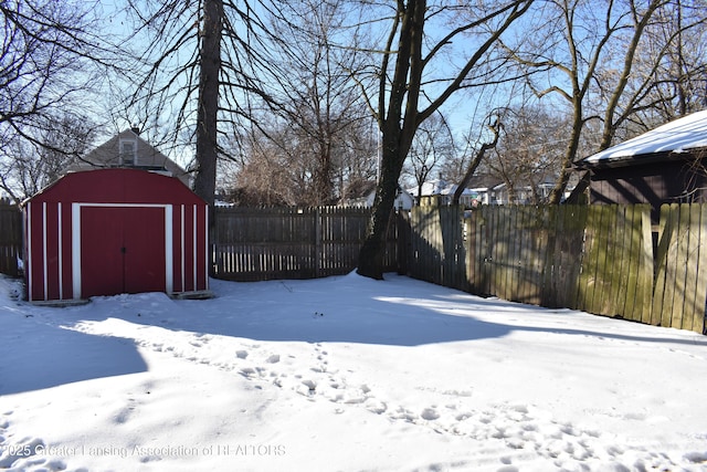 snowy yard with a storage unit