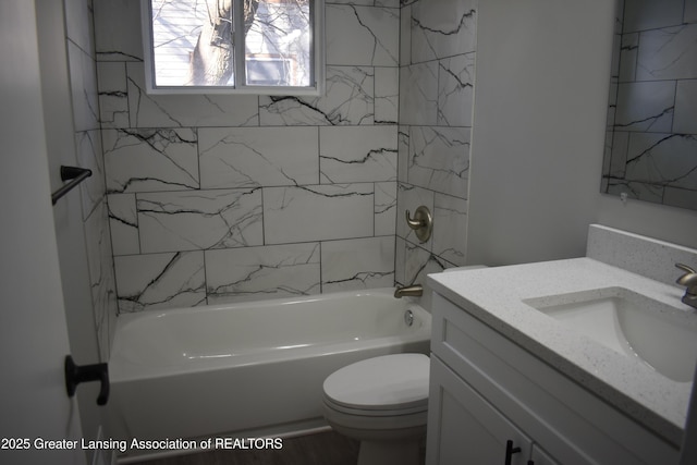 full bathroom with vanity, toilet, and tiled shower / bath combo