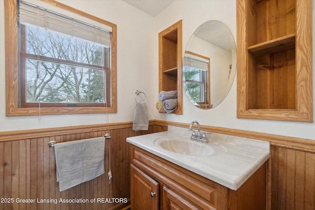 bathroom featuring vanity and wooden walls