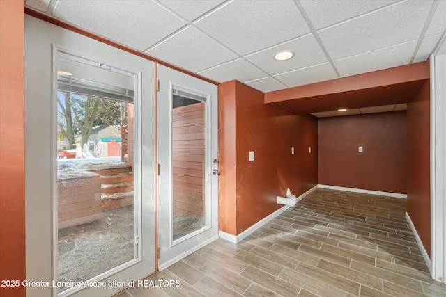 entryway featuring hardwood / wood-style flooring and a paneled ceiling