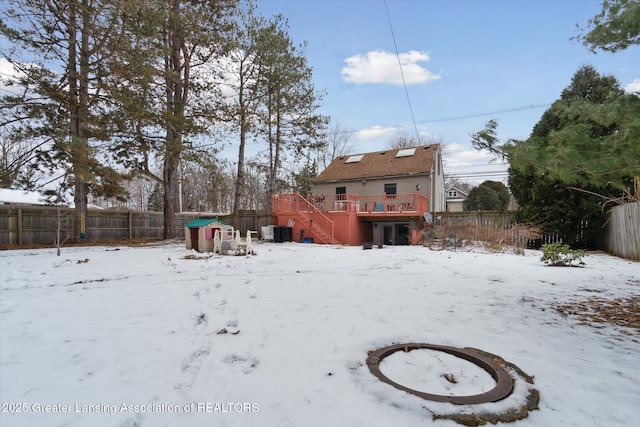 yard covered in snow with a deck