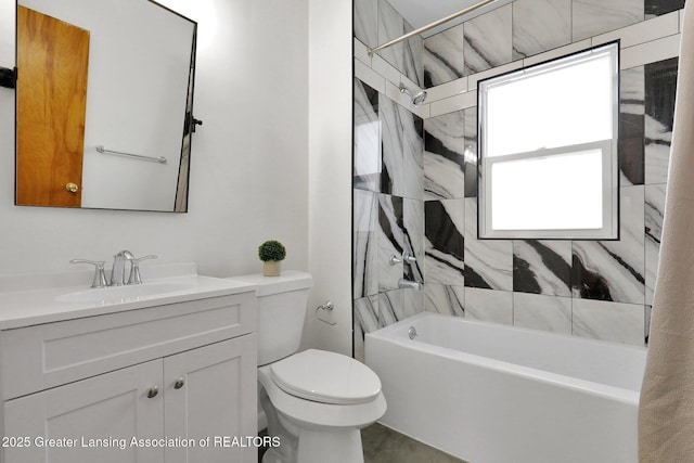 full bathroom with vanity, tiled shower / bath, and toilet