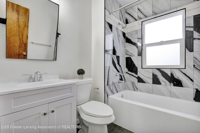 full bathroom with vanity, toilet, and tiled shower / bath combo