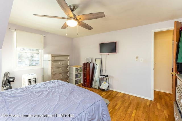 bedroom with ceiling fan and light hardwood / wood-style floors