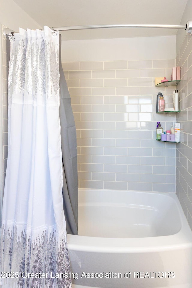 bathroom featuring shower / bathtub combination with curtain