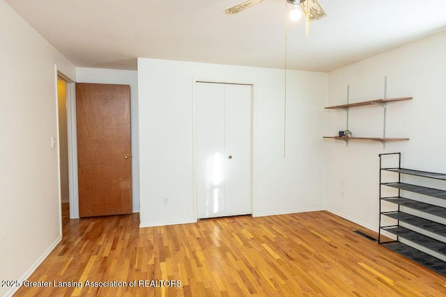 unfurnished bedroom with a closet and light hardwood / wood-style flooring