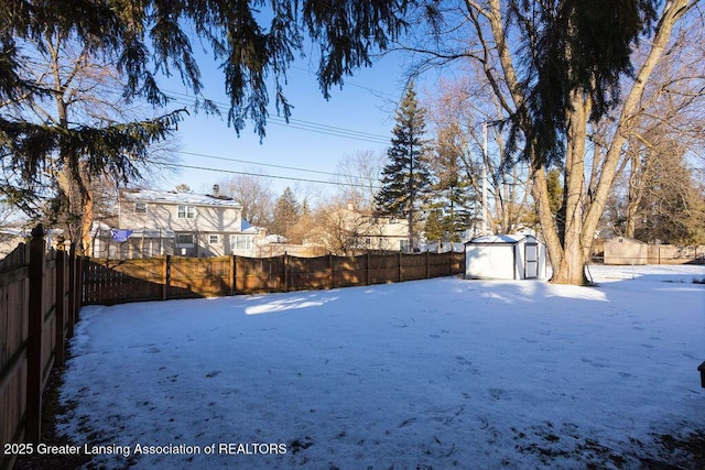 snowy yard with a shed