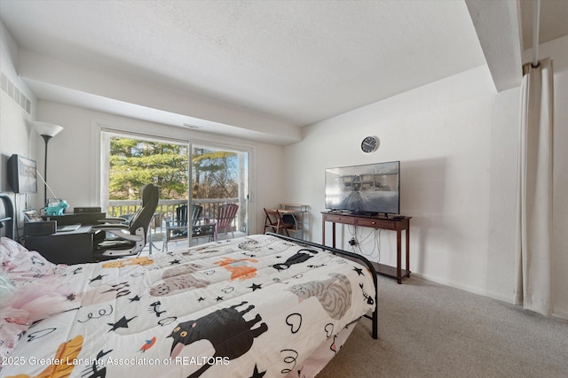 carpeted bedroom featuring access to outside and a textured ceiling