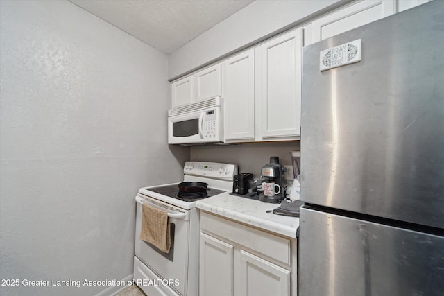 kitchen with white cabinets and white appliances