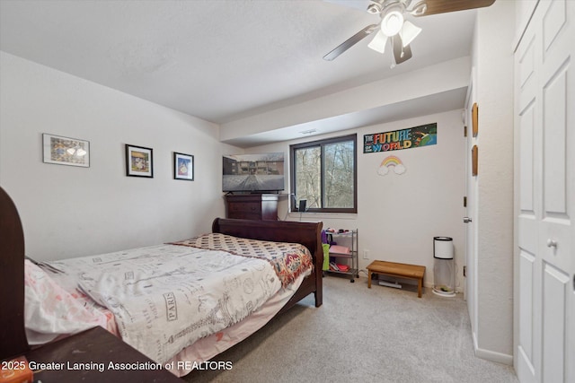 bedroom with ceiling fan and light carpet