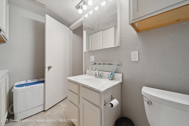 bathroom with vanity, tile patterned floors, and toilet