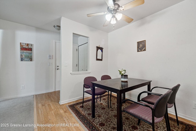 dining room with hardwood / wood-style floors and ceiling fan