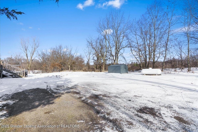 snowy yard with a storage unit