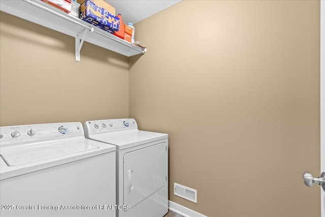 washroom featuring washing machine and clothes dryer