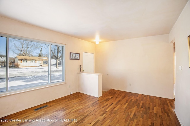 unfurnished room featuring hardwood / wood-style flooring