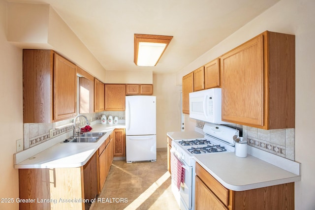 kitchen with sink, backsplash, and white appliances