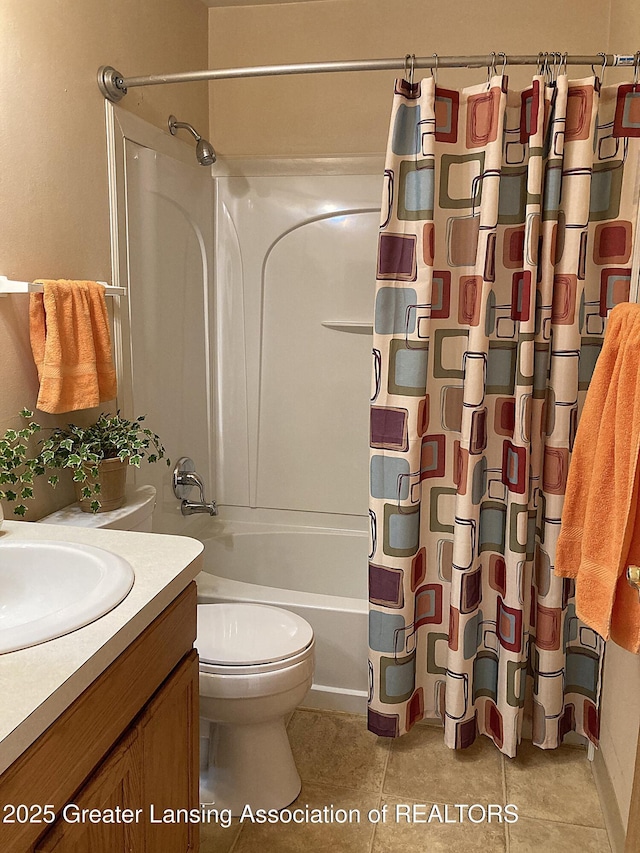 full bathroom featuring tile patterned floors, vanity, toilet, and shower / bath combo with shower curtain