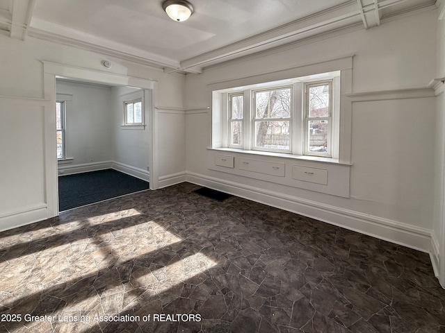 empty room featuring crown molding