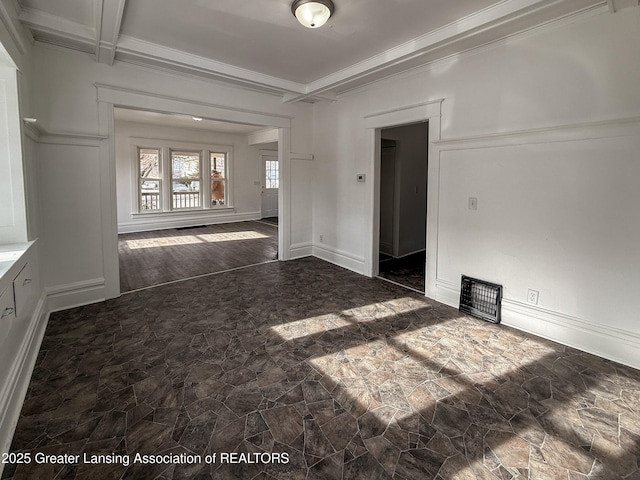 unfurnished room featuring coffered ceiling, ornamental molding, and beam ceiling