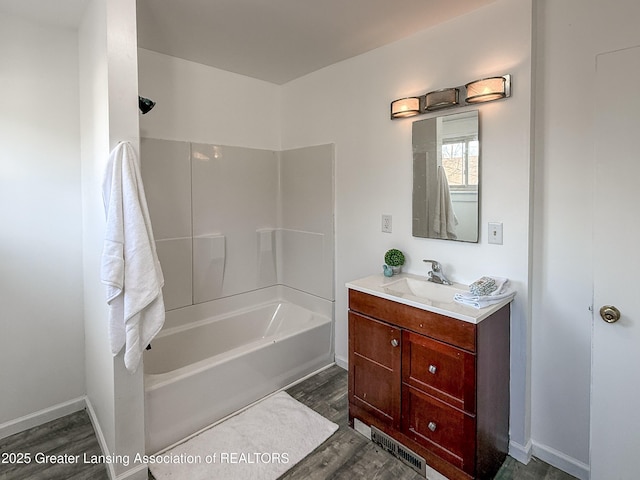 bathroom with hardwood / wood-style flooring, vanity, and bathtub / shower combination