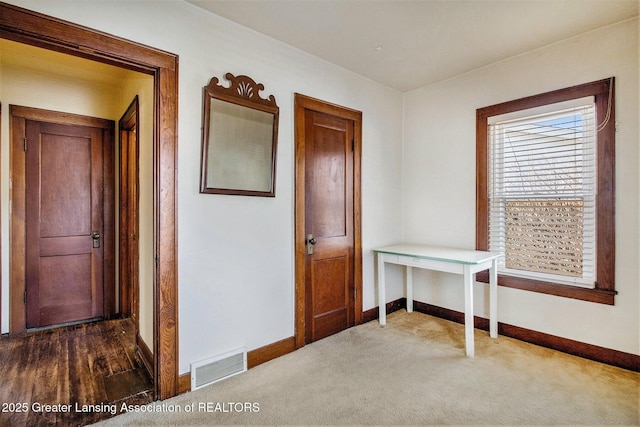 hallway featuring dark carpet