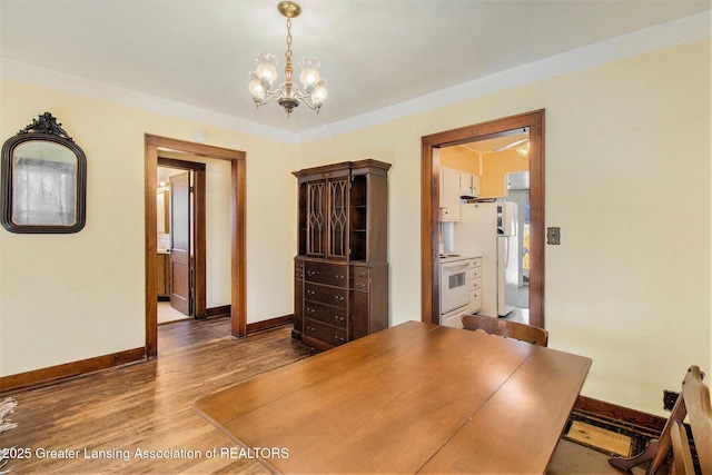 dining area featuring hardwood / wood-style flooring and a chandelier