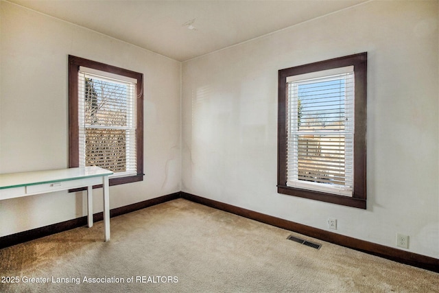 unfurnished room with light colored carpet