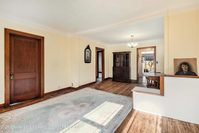 interior space with dark hardwood / wood-style flooring and an inviting chandelier